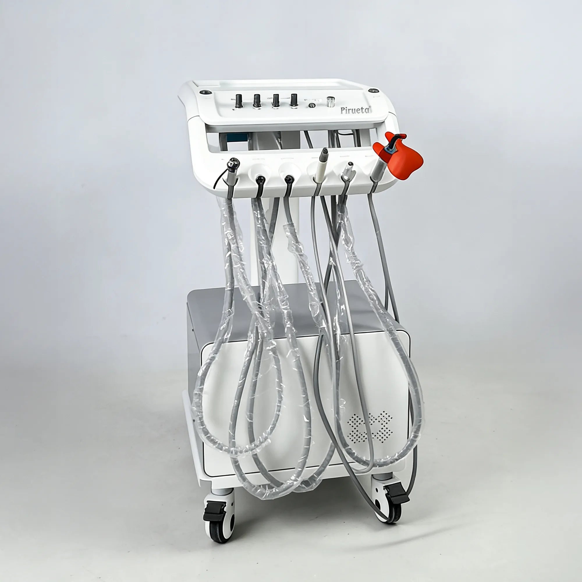 Angled view of the veterinary dental station highlighting the protective curing light shield and tubing for high-speed and low-speed handpieces