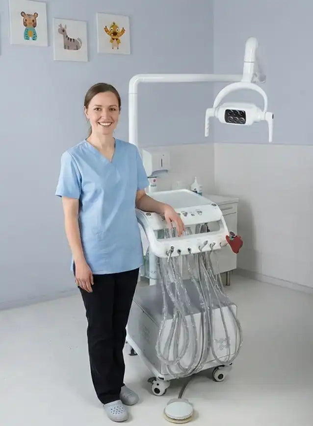 Close-up view of a PIRUETA mobile veterinary dental cart featuring handpiece tubing and an ultra-quiet compressor, used by a veterinary professional.