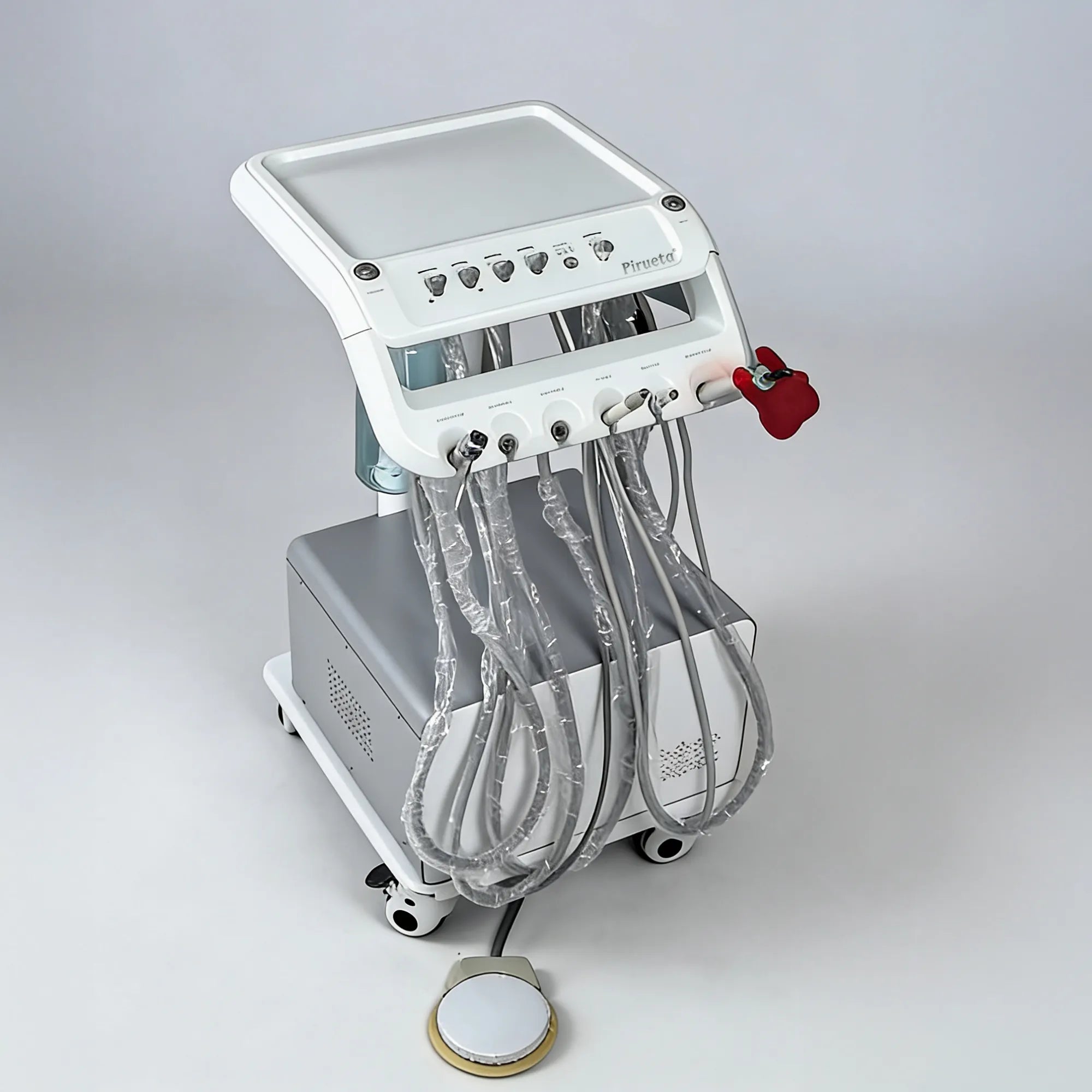 Top-down angled view of the mobile unit for veterinary dentistry, featuring a clean white finish, instrument tray, and a standard foot-pedal control